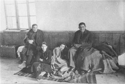 A family of Macedonian Jews in the Tobacco Monopoly transit camp in Skopje before deportation. Skopje, Yugoslavia, March 1943.
The Jews of Bulgarian-occupied Thrace and Macedonia were deported in March 1943. On March 11, 1943, over 7,000 Macedonian Jews from Skopje, Bitola, and Stip were rounded up and assembled at the Tobacco Monopoly in Skopje, whose several buildings had been hastily converted into a transit camp. The Macedonian Jews were kept there between eleven and eighteen days, before being deported by train in three transports between March 22 and 29, to Treblinka.