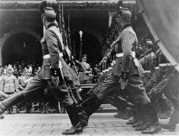 German police parade before Adolf Hitler in front of Hotel Deutsches Haus, at a Nazi Party Congress rally. [LCID: 69508]