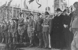 Adolf Hitler et son entourage regardent un défilé militaire à la suite de l’annexion de l’Autriche (l’Anschluss). Vienne, Autriche, mars 1938.