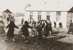 Niños romaníes (gitanos) juegan afuera del campo de reclusión de Jargeau. El campo se había establecido en respuesta a una orden alemana en octubre de 1940 de arrestar y confinar en los campos a todos los franceses o extranjeros en la región de Loiret que no tuvieran residencia permanente. Jargeau, Francia, 1941-1945.