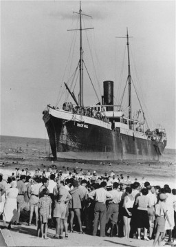Aliyah Bet ("illegal" immigration) ship "Tiger Hill," carrying Jewish refugees from Europe, lands in Tel Aviv, Palestine. [LCID: 69440]
