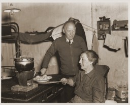 A Jewish refugee family prepares food with rations provided by the United Nations Relief and Rehabilitation Administration (UNRRA). [LCID: 66382]