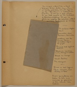 Scrapbook page with handwritten notes in black ink containing one closed folded piece of blue paper in the center.