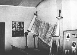 A display, entitled "British Freemasonry," at an antisemitic and anti-Masonic exhibition in Berlin. The display shows a Torah scroll and a picture of King Edward bearing Masonic regalia. Berlin, Germany, March 7, 1941.