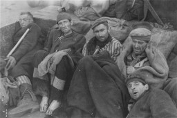 Survivors of the Wöbbelin camp wait for evacuation to an American field hospital where they will receive medical attention. [LCID: 09280]