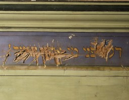 The damaged lintel above a Torah ark from a synagogue that was destroyed during Kristallnacht. [LCID: n00319]