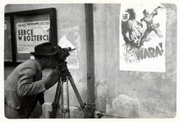 Julien Bryan films an anti-Nazi poster in Warsaw,  1939