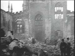 On the night of November 14-15, 1940, almost 500 German bombers attacked the British industrial city of Coventry in central England. The bombers dropped 150,000 incendiary bombs and more than 500 tons of high explosives. The air raid destroyed much of the city center, including 12 armament factories and the historic Saint Michael's Cathedral. This footage shows scenes from the aftermath of the attack. The bombing of Coventry came to symbolize, to Britain, the ruthlessness of modern air warfare.