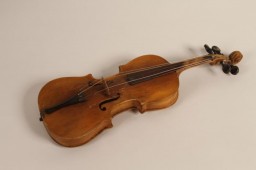 A childsize violin that belonged to Boruch Golden (Gordon), who was killed along with his mother and brother at the Ponary killing site in September 1943. 
Boruch was born in 1930, and was one of four children. His parents, Moshe and Basia Golden (Gordon), raised their family in Swieciany (Svencionys), Lithuania. After the German invasion of the Soviet Union in June 1941, the family was forced into the Swieciany ghetto. When that ghetto was later liquidated in 1943, the family was sent to the Vilna ghetto. Later that year, the Vilna ghetto was also liquidated. Boruch, only 13 years old at the time, was murdered at Ponary along with his mother and brother.
The violin was saved by his sister, Niusia (now Anna Nodel), who survived the war in hiding.
