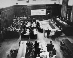 The courtroom during the Einsatzgruppen Trial of the Subsequent Nuremberg Proceedings. Chief Prosecutor Benjamin Ferencz stands in the center of the room. He is presenting evidence. Nuremberg, Germany, between September 29, 1947, and April 10, 1948. 