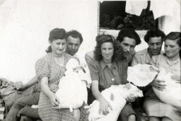 Three couples pose with their babies in the Gabersee displaced persons (DP) camp in Germany, 1947. In the center are David and Bella Perl (later spelled Pearl), who met and married after the war, with their daughter, Rachel.
During the Holocaust, Bella Scheiner and her family were deported to Auschwitz. From there, she was sent to forced labor at Reichenbach, a sub-camp of Gross-Rosen. Bella met David—who had lost his wife and child during the war—while working at a photography studio after liberation. They married in 1946 and traveled to Gabersee, where Rachel was later born. After nearly three years in the DP camp, the Perls immigrated to the United States.