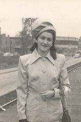 Lisa wearing the first suit she bought in America (Aron recollected that it was taupe). Lisa's aunt, Faye Abrams, gave her the money to buy this suit. Photograph taken in 1947 in Chicago, Illinois, at the Illinois Central station, 75th street (Lisa was either coming or going from downtown).
