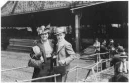 A Jewish refugee couple poses on the gangway of the MS St. Louis as they disembark from the ship in Antwerp. Belgium, June 17, 1939.  