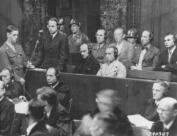 <p>Otto Ohlendorf, commander of Einsatzgruppe D (mobile killing unit D), during Trial 9 of the Subsequent Nuremberg Proceedings. This photograph shows Ohlendorf pleading "not guilty" during his arraignment at the <a href="/narrative/9545">Einsatzgruppen Trial</a>. Nuremberg, Germany, September 15, 1947.</p>