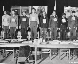 A group of the 19 men accused of committing atrocities at the Dora-Mittelbau concentration camp, located near Nordhausen, during ... [LCID: 43065]