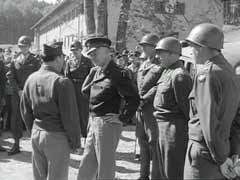 In this footage, General Dwight Eisenhower, General George Patton, and Major General Lewis Craig inspect conditions at the Feldafing displaced persons camp near Wolfratshausen, Germany. Feldafing was one of the first displaced persons camps to house primarily Jewish refugees. In August 1945, Eisenhower ordered that Feldafing be used as a model for the establishment of other camps for Jewish displaced persons in the US occupation zones of Germany and Austria.