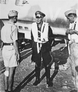 Erwin Rommel (center), commander of the Africa Corps, at an airfield in Libya during an Axis offensive into neighboring Egypt. [LCID: 90440]