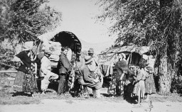 A photographer with a group of nomadic Roma (Gypsies). [LCID: 60144]