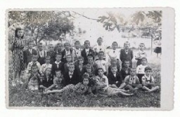 Gavra Mandil and his family narrowly escaped death in German-held Yugoslavia by fleeing to Italian-occupied Albania. There Gavra attended a school in Kavaja that had both Muslim and Christian pupils. He is seated on the far right in the first row. June 1943.