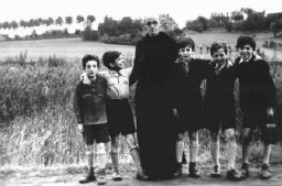 Father Bruno with Jewish children he hid from the Germans. Yad Vashem recognized Father Bruno as "Righteous Among the Nations." Belgium, wartime.