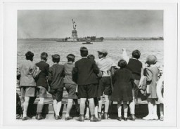 Children aboard the President Harding look at the Statue of Liberty as they pull into New York harbor. They were brought to the United States by Gilbert and Eleanor Kraus. New York, United States, June 1939.