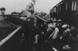 Jews from the Lodz ghetto are forced to transfer to a narrow-gauge railroad at Kolo during deportation to the Chelmno killing center. Kolo, Poland, probably 1942.