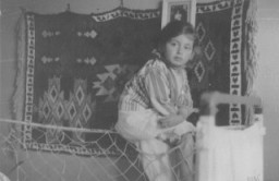 <p>Portrait of a young Jewish girl, Lida Kleinman sitting in her room in Lacko, Poland, 1935. In January 1942, Lida was sent into hiding. She <a href="/narrative/7723">hid under false identities</a> in Catholic orphanages until the end of the war.</p>