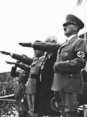 Adolf Hitler salutes the Olympic flag at the opening of the Olympic Games in Berlin. Germany, August 1, 1936.