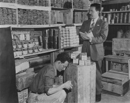 Morris Laub (right), Joint Distribution Committee director for Cyprus, reviews supplies sent for the 12,000 Jews still interned on ... [LCID: 63189]