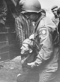 A chaplain with the 82nd Airborne Division helps a survivor board a truck that will evacuate him from the Wöbbelin concentration ... [LCID: 77018]
