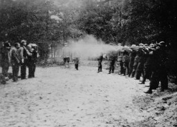 The execution of Poles in the Barbarka Forest by members of the Selbstschutz (ethnic German self-defense organization). An SS officer can be seen standing in the background. Torun, Bydgoszcz, Poland, October 1939.