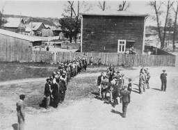 Employees of the Jewish council in the Kovno ghetto assemble during roll call, which was taken on a daily basis. [LCID: 70895]
