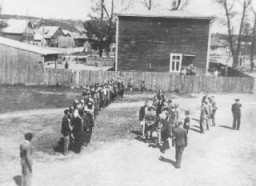 Employees of the Jewish council in the Kovno ghetto assemble during roll call, which was taken on a daily basis. Kovno, Lithuania, 1941–43.