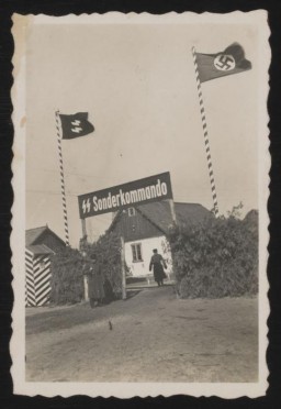View of the Sobibor camp gate in the spring of 1943. Jews deported to the Sobibor killing center were driven through the gate into the camp on foot, by truck or horse-drawn cart. The train track led through a separate entrance to the right onto the site. Pine branches were braided into the fence to make it difficult to see in from the outside.
This image comes from an album and collection kept by Johann Niemann, who became deputy commandant of the Sobibor killing center after holding positions in the "euthanasia" program and in other camps.