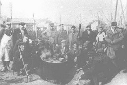Jews prepare soup outside the Monopol tobacco factory transit camp