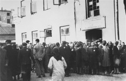 Jews in the Lodz ghetto line up outside the labor office of the Jewish council in the hopes of finding employment outside the ghetto. [LCID: 80561]