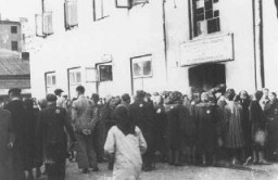 Jews in the Lodz ghetto line up outside the labor office of the Jewish council in the hopes of finding employment outside the ghetto. Lodz, Poland, between 1941 and 1943.