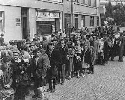 Jewish refugees, part of Brihah—the postwar flight of Jews—in line at a relief center. They are en route to the Allied occupation zones in Germany and Austria. Nachod, Czechoslovakia, 1946.