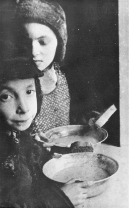 In the Warsaw ghetto, Jewish children with bowls of soup. [LCID: 51733]