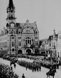 In the aftermath of the Munich agreement, which turned the Sudetenland of Czechoslovakia over to Germany, German troops march into ... [LCID: 70026]