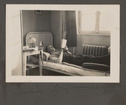 Staff member Johann Niemann in his room at the Bernburg "euthanasia" center. For the picture, he turned his family photo on the bedside table in the direction of the photographer. Niemann later became the deputy commandant of Sobibor, one of three "Operation Reinhard" killing centers.  