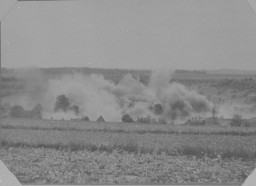 Lidice in smoke. The Nazis destroyed the Czech village in reprisal for the assassination by Czech resistance fighters of Reinhard ... [LCID: 51268]