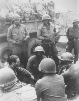 Members of the 12th Armored Division, which included African American platoons, await their orders. [LCID: 83791]