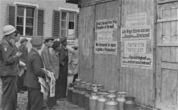 Jewish survivors in a displaced persons camp post signs calling for Great Britain to open the gates of Palestine to the Jews. [LCID: 00171]