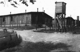A watchtower and barracks at the Ohrdruf subcamp of the Buchenwald concentration camp. This photograph was taken after the US 4th Armored Division liberated the camp. Ohrdruf, Germany, June 1945.