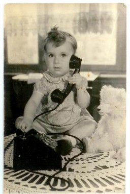 Robert Coopman was born in the Netherlands in September 1940.  This 1941 photograph shows Robert holding a telephone while sitting next to a teddy bear. He and his parents lived in Amsterdam where his father was a salesman and bookkeeper. 
In July 1942, fearing for their safety, Robert's parents placed him in hiding with the Viejou family in Naarden.  He was less than two years old. He lived as a member of the household until August 1944, when a neighbor betrayed them.
Robert was  eventually deported to Theresienstadt.  His parents were deported to Sobibor. 
Although malnourished and ill, Robert survived Theresienstadt. The Viejous eventually found Robert and after he had recuperated, he returned to live with his rescuer family until he was 18 years old. 
 
