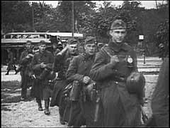 Germany invaded Poland on September 1, 1939, beginning World War II. German forces swiftly overran Polish border defenses and approached Warsaw, Poland's capital city. Warsaw suffered heavy air attacks and artillery bombardments during the campaign. The city surrendered on September 28. This footage shows German forces entering Warsaw amidst the destruction caused by their bombardment of the city.