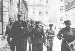 Amon Goeth (front left), commandant of the Plaszow camp, under escort to the courthouse in Kraków for sentencing. He was sentenced to death at his postwar trial on war crimes charges. Kraków, Poland, August 1946.
