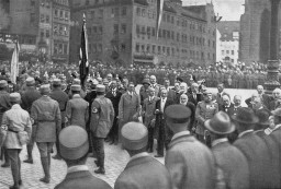 Adolf Hitler, Julius Streicher, and other dignitaries review passing Nazi Party members at the Deutscher Tag (German Day) celebration in Nuremberg, September 02, 1923.