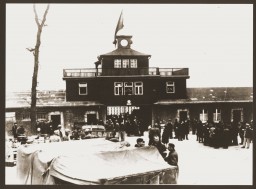 Members of a resistance organization in the camp meet with American soldiers in front of the entrance to the Buchenwald concentration ... [LCID: 0069x]